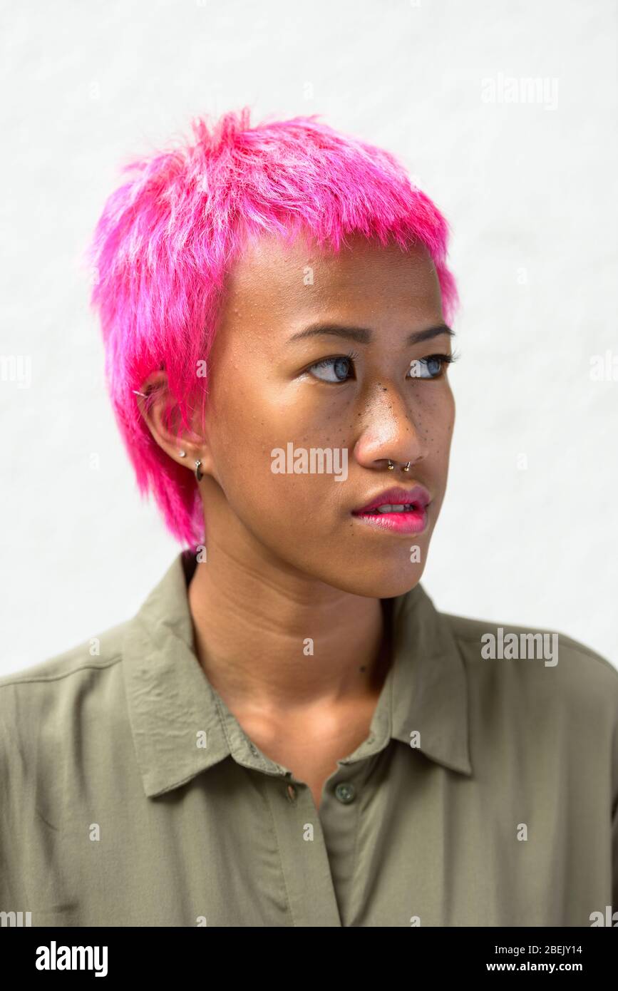 Face of young rebellious Asian woman with pink hair thinking Stock Photo -  Alamy