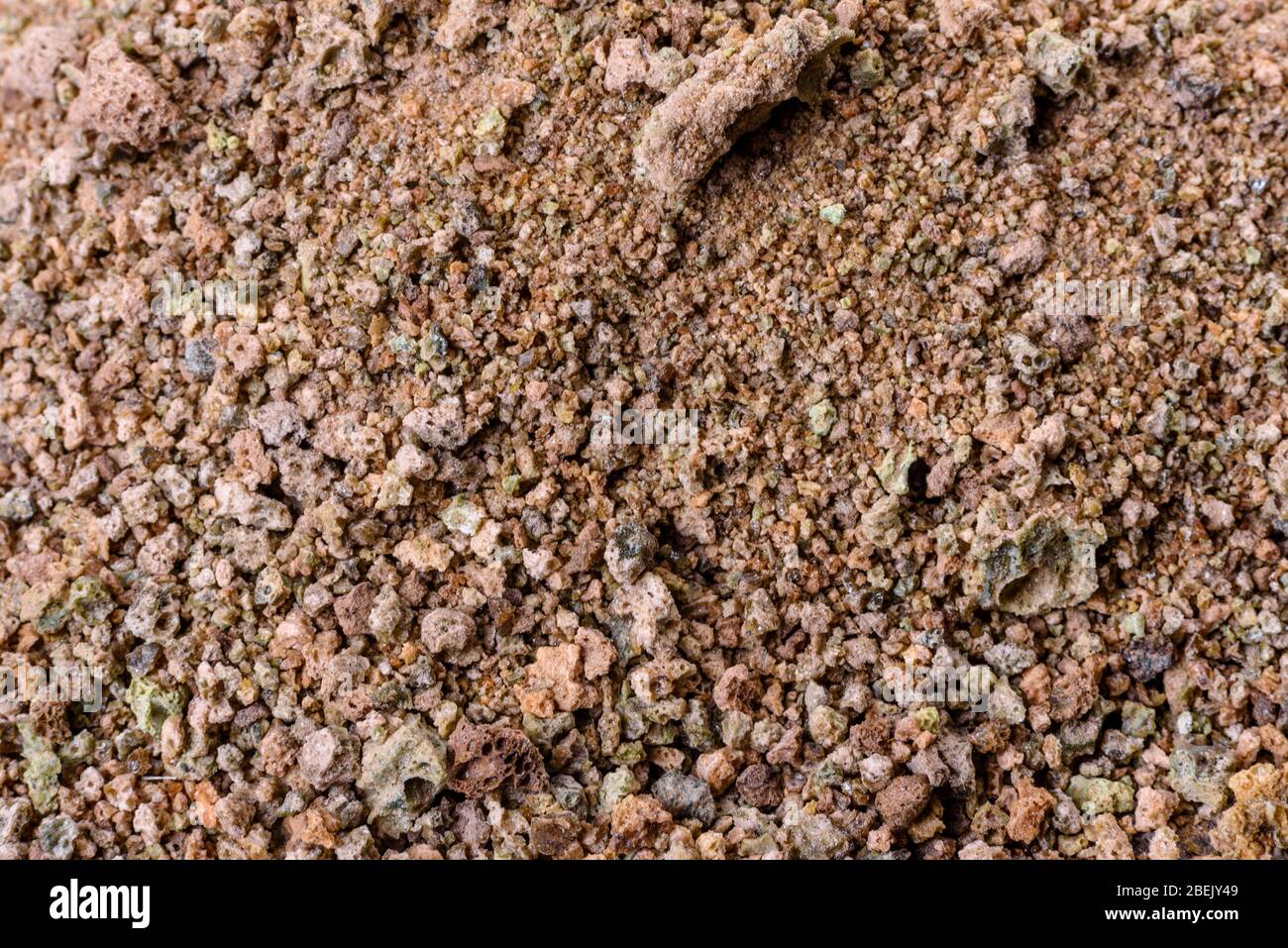 Crushed rock. Small rocks ground. Crushed stone road building