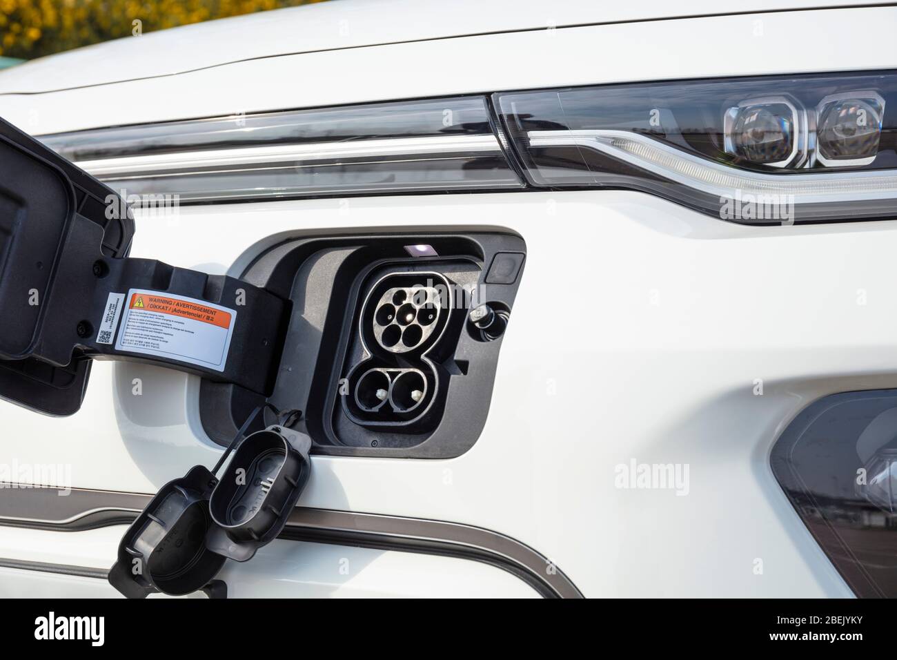 New electric car Kia E Soul march 2020 electric car charging port CCS charging port on the front of the car with front flap open for charging uk Stock Photo
