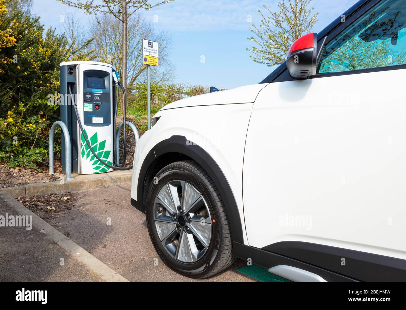 New electric car Kia E Soul march 2020 electric car charging at a public electric car charger parked in electric car charging parking space UK Stock Photo