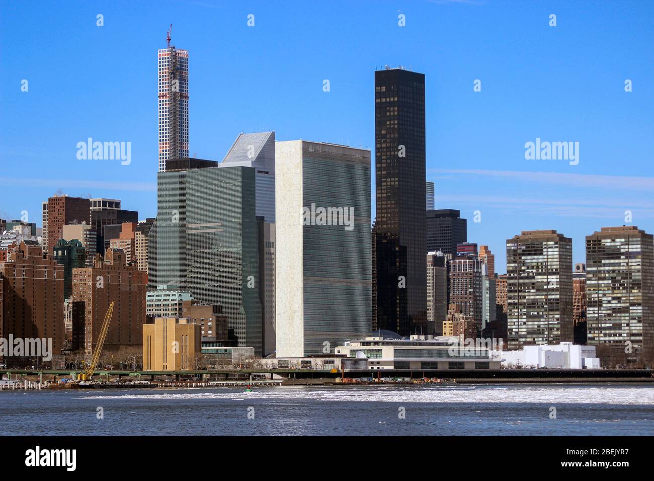 United Nations Headquarters and Trump World Tower viewed over icy East River in New York City, United States of America Stock Photo
