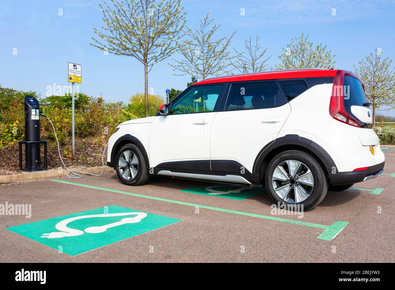 New electric car Kia E Soul march 2020 electric car charging at a public electric car charger parked in electric car charging parking space UK Stock Photo