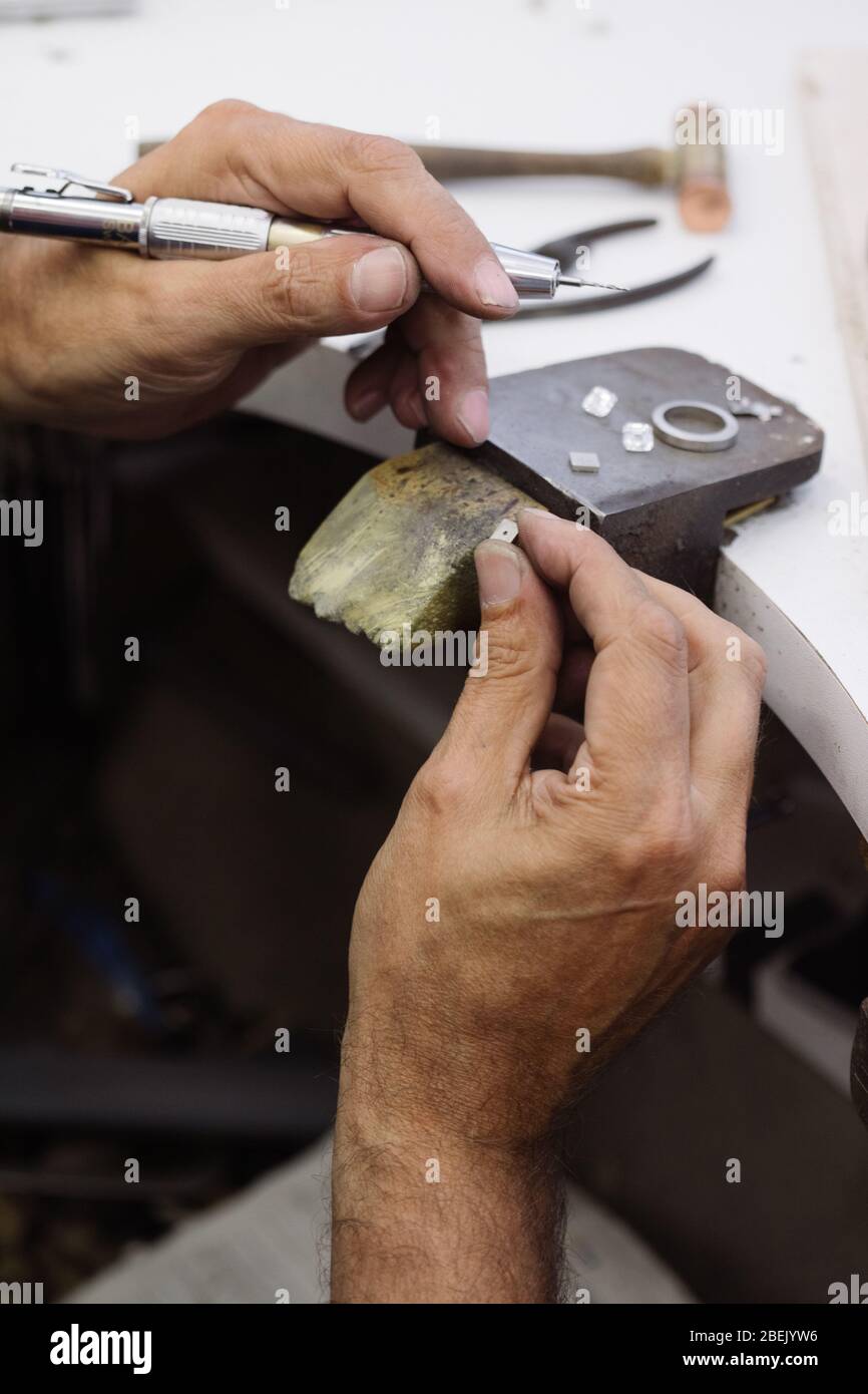 Jeweller working on a ring on a jewellers bench Stock Photo Alamy