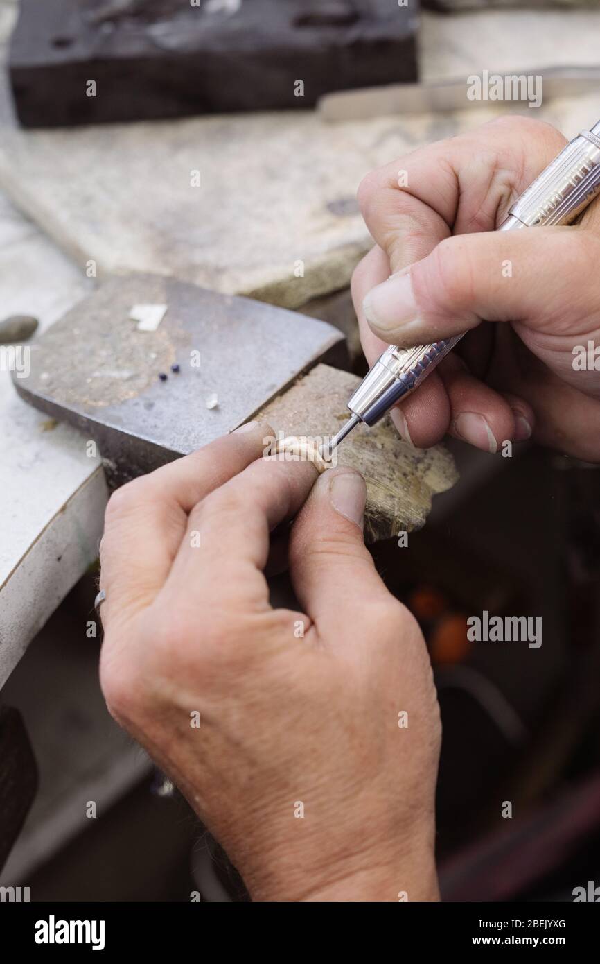 Jeweller working on a ring on a jewellers bench Stock Photo Alamy
