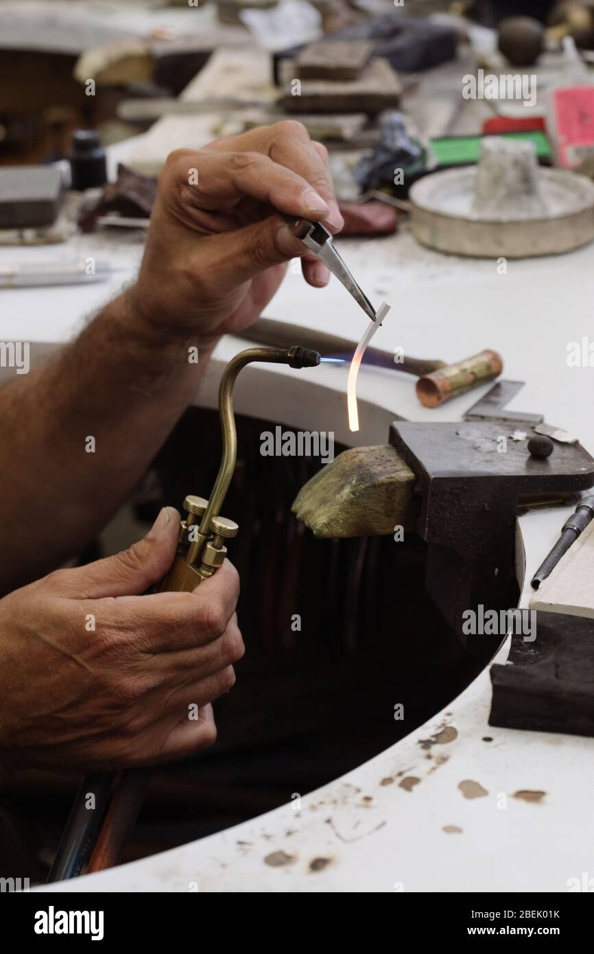 Golden ring soldering with help of gas torch by a jeweller Stock Photo