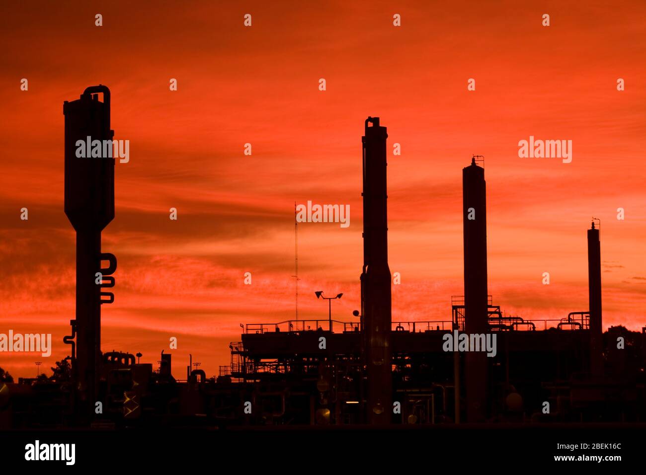 Industry silhouetted against an orange sky. Stock Photo