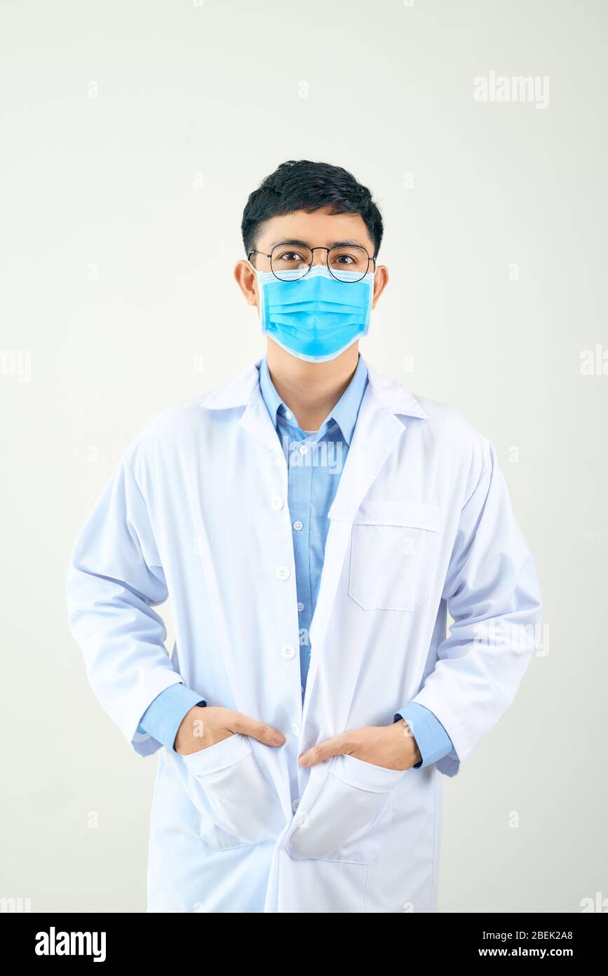 Young asian man in medical field, wearing a white coat and face mask ...