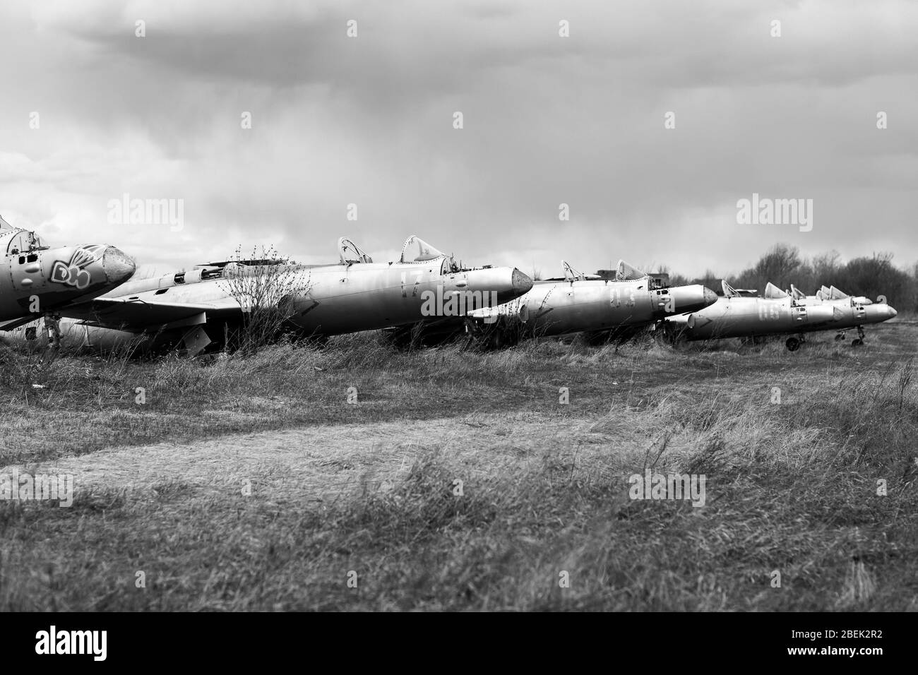 Old destroyed Soviet abandoned military airplanes in the field in Ukraine, black and white. Former soviet aviation wreckage after second world war Stock Photo
