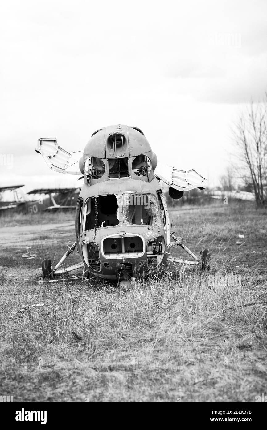 Old destroyed Soviet abandoned military airplanes in the field in Ukraine, black and white. Former soviet aviation wreckage after second world war Stock Photo