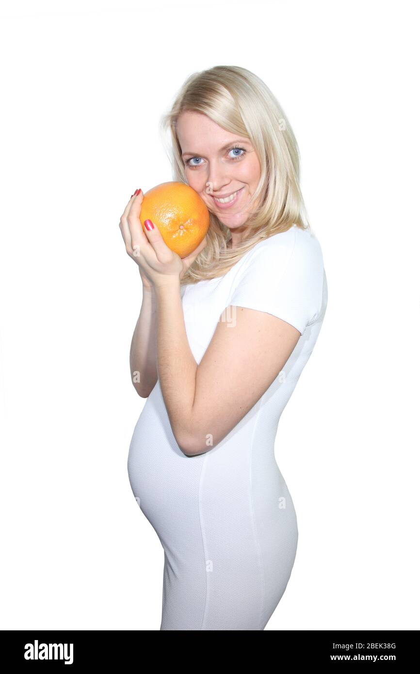 Young Petty Natual Beauty Pregnant Woman Holding Grapefruit and Shows a
