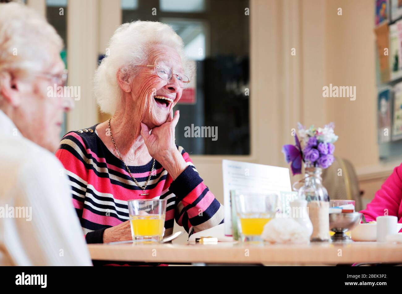 A pensioner using the Age UK cafe in Darlington, County Durham, UK. 4/9/2017. Photograph: Stuart Boulton. Stock Photo