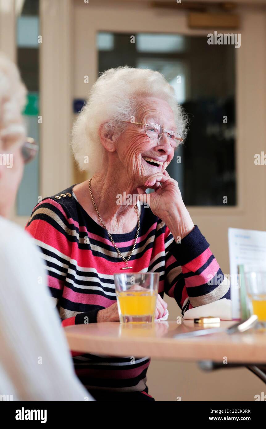 A pensioner using the Age UK cafe in Darlington, County Durham, UK. 4/9/2017. Photograph: Stuart Boulton. Stock Photo