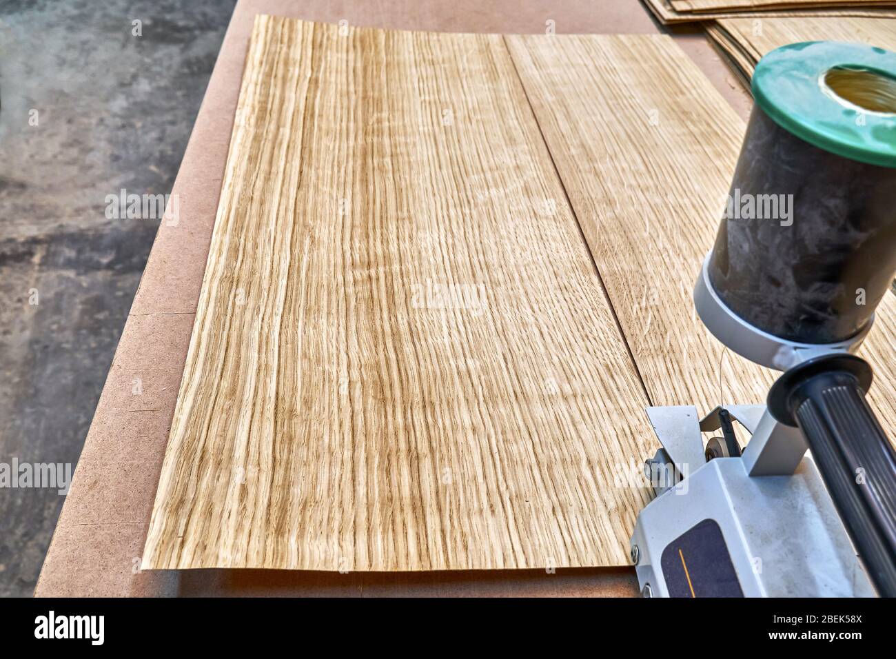 Oak veneer. Oak texture. Veneer splicing process with veneer hand