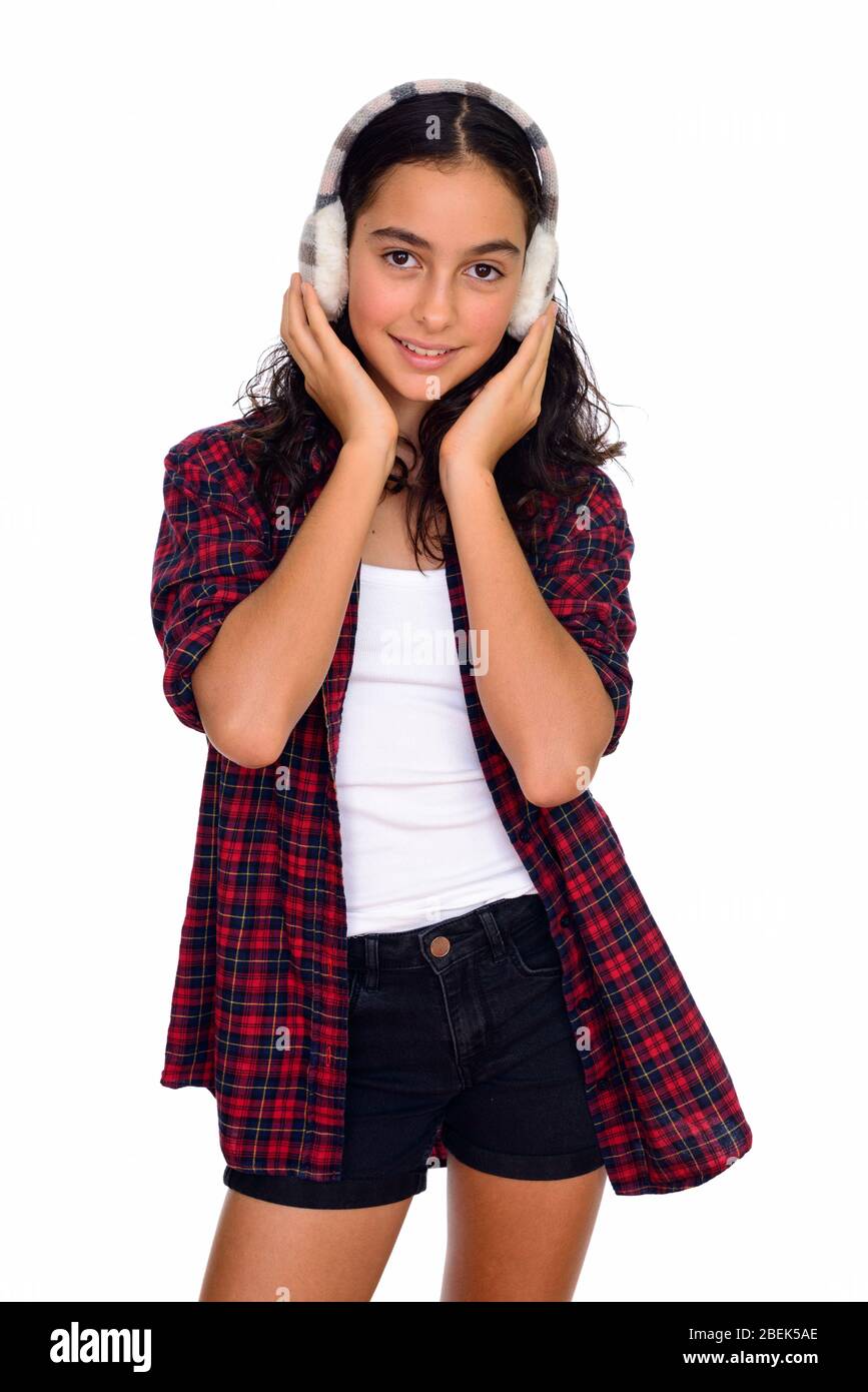 Studio shot of young beautiful teenage girl ready for winter isolated against white background Stock Photo