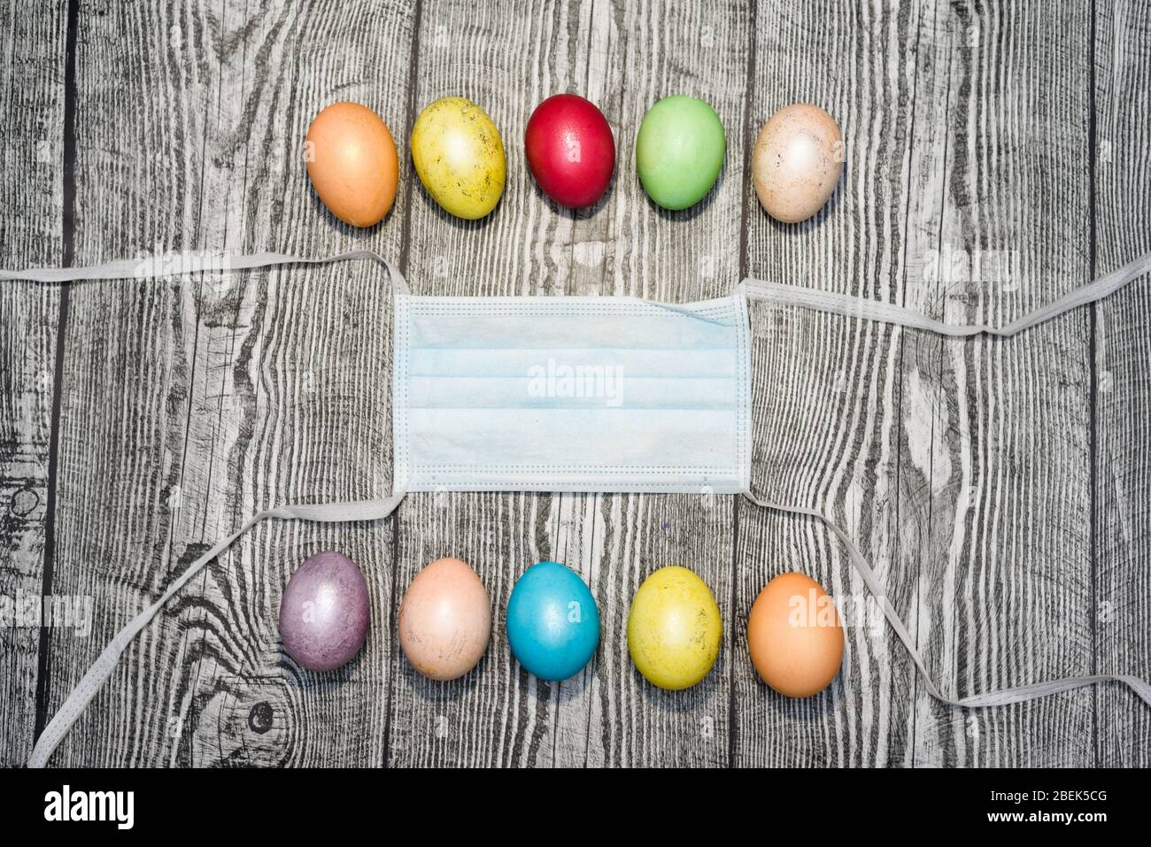 Download Three Colored Yellow Easter Eggs Laying In Medical Mask On The Wooden Background Coronavirus Covid 19 Concept Photo Easter 2020 Stock Photo Alamy PSD Mockup Templates