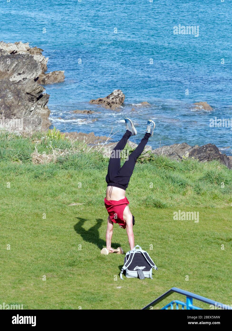 Newquay,Cornwall, 14th April 2020. UK weather: Sunshine and handstands during outdoor morning workout at Fistral Bay. Credit: Robert Taylor/Alamy Live News” Stock Photo