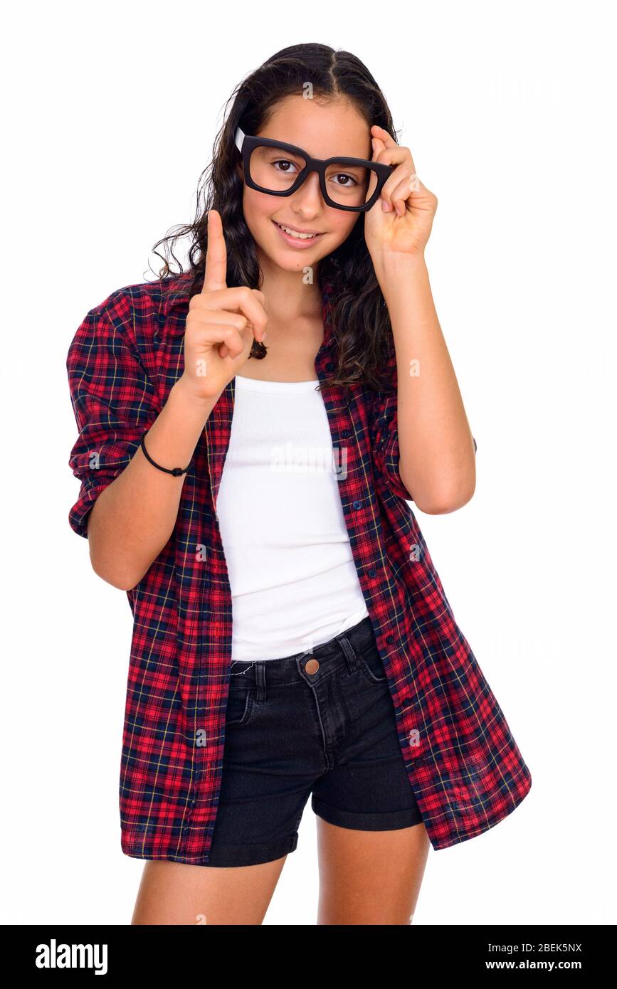 Studio shot of young beautiful teenage girl pointing finger isolated against white background Stock Photo
