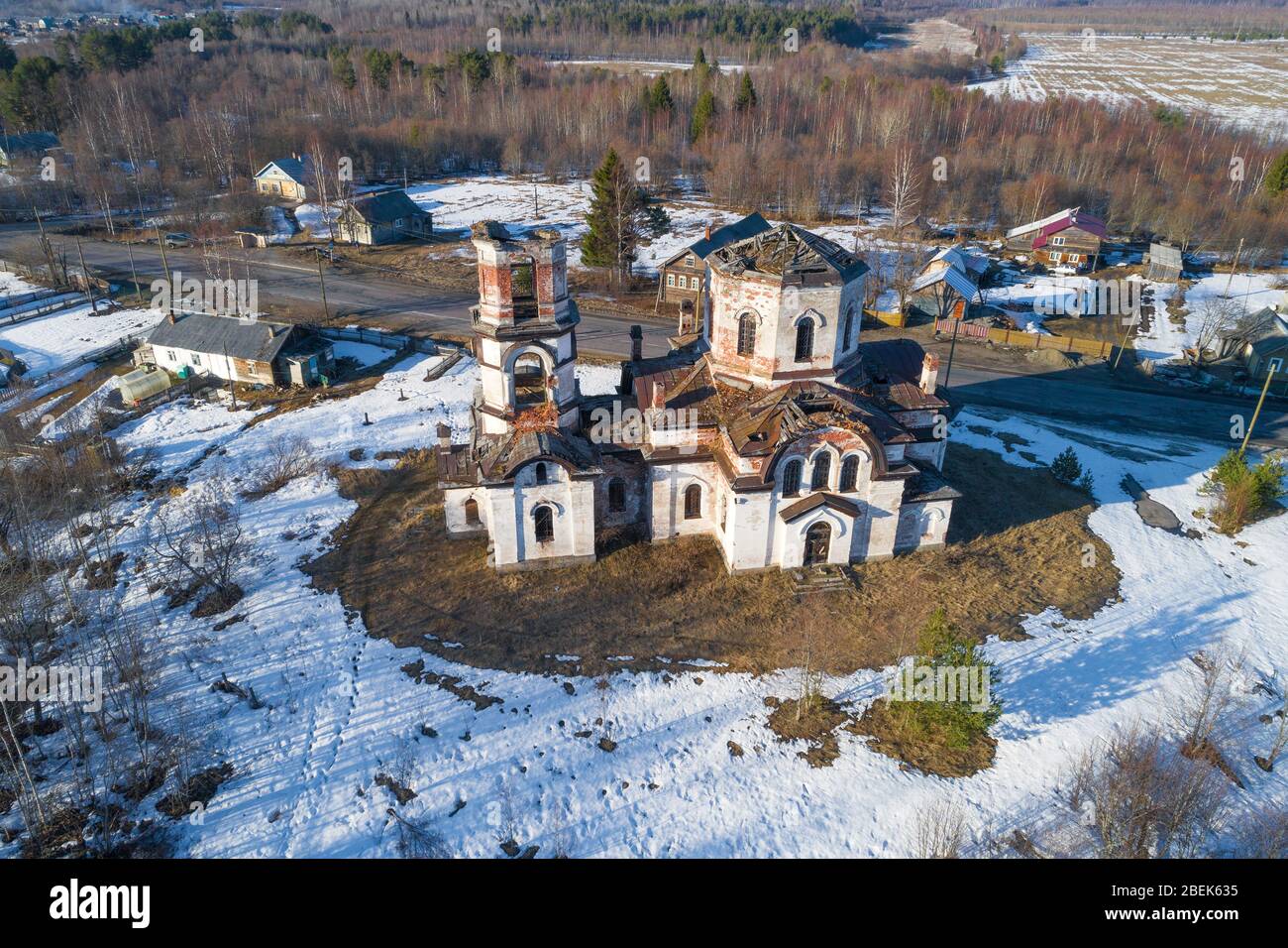 Old abandoned Rozhdestvenskaya church in the village of Verkhruchey on a April day (aerial photography). Karelia, Russia Stock Photo