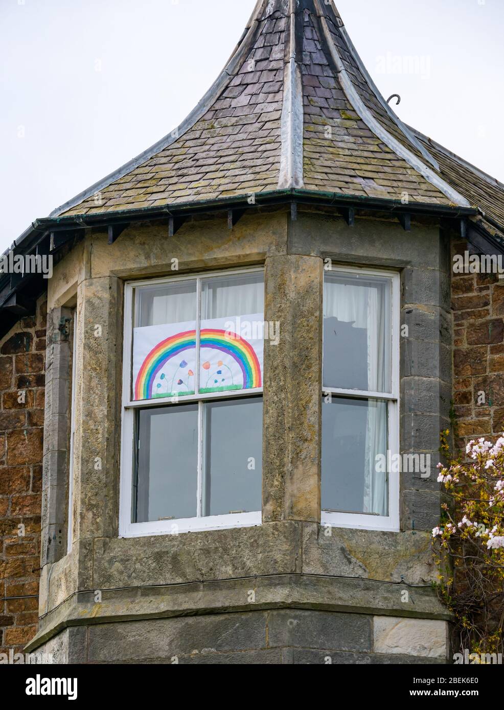 Coronavirus Covid-19 hope rainbow drawing in Victorian house window during pandemic lockdown, East Lothian, Scotland, UK Stock Photo