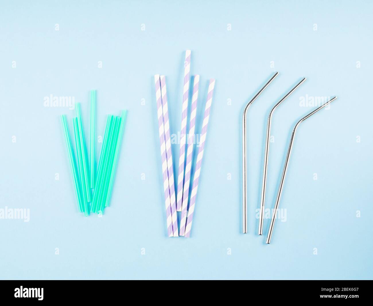 Different material drinking straws on pastel blue Stock Photo