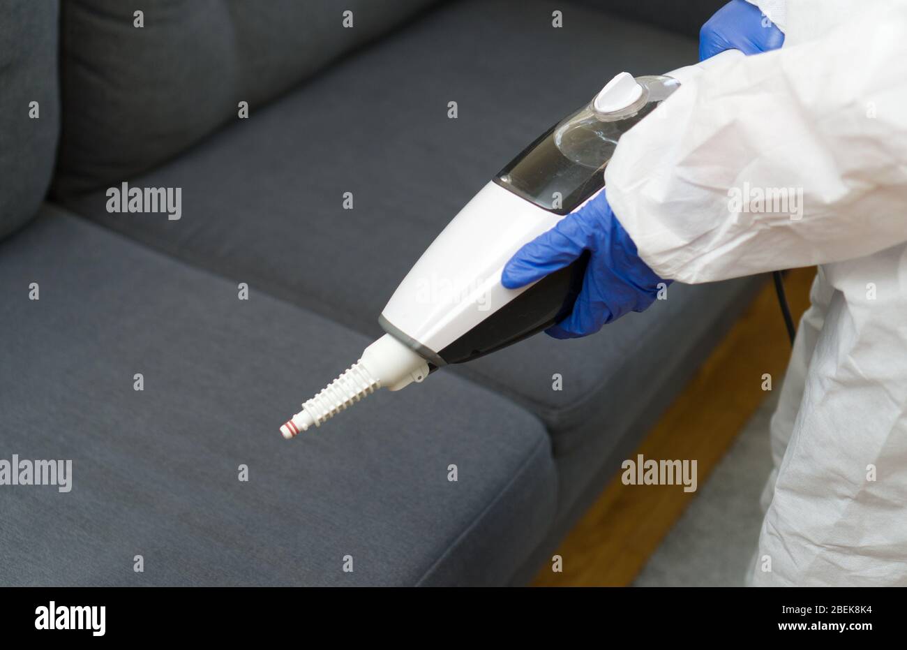 Cleaner in biohazard suit disinfecting room Stock Photo Alamy