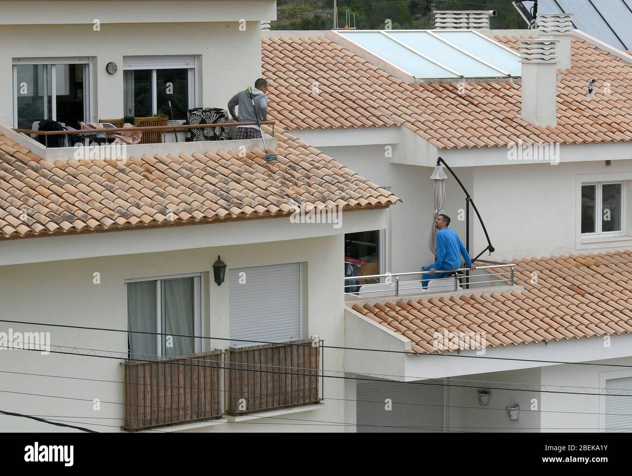 Altea La Vella, Alicante Province, Spain, March 21st, 2020, two young men on their balconies Stock Photo