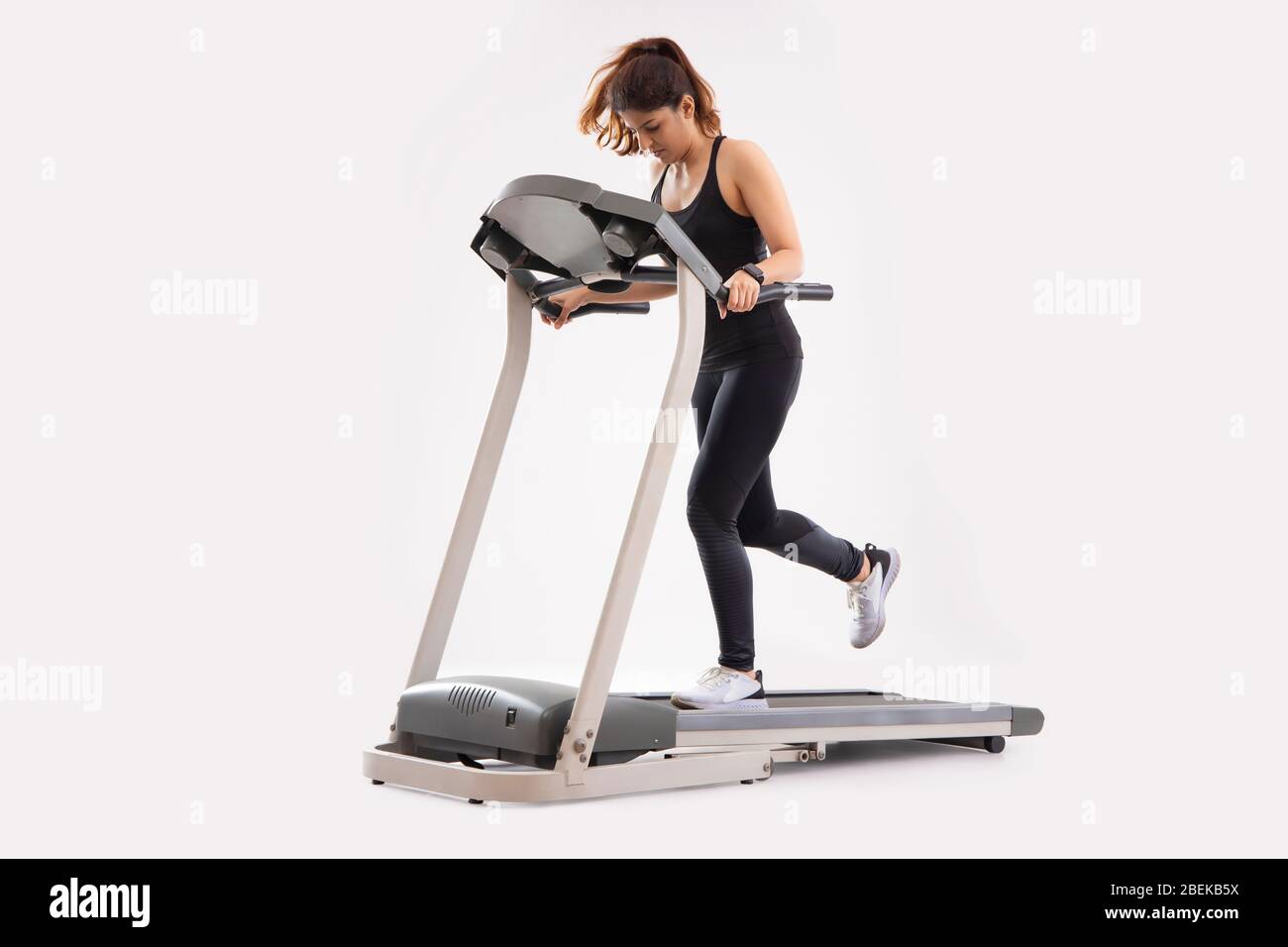 Woman running on the treadmill during her workout Stock Photo Alamy