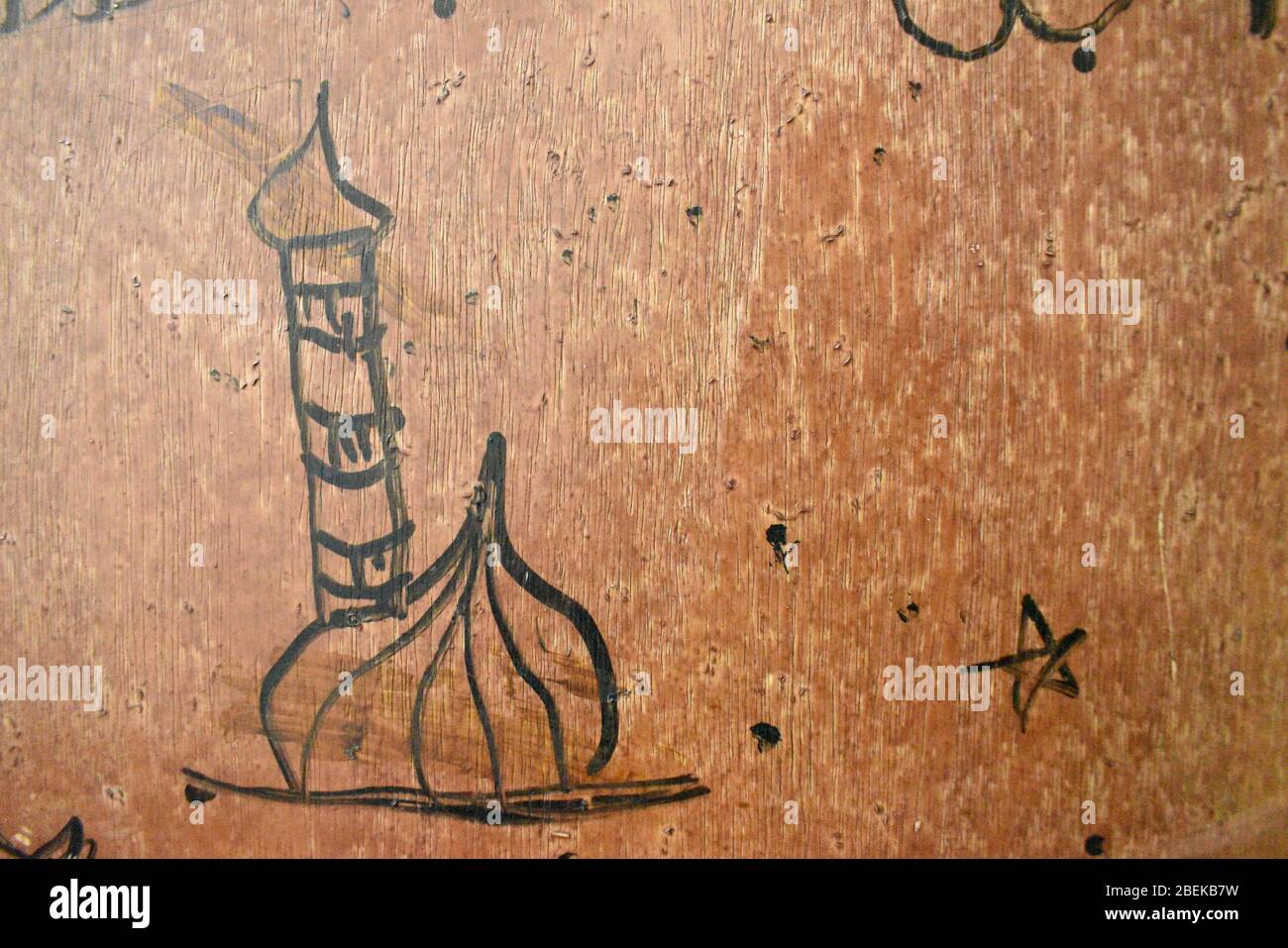 closeup view of mosque draw by one kid with black paint in brown background door.Day time photography with Nikon camera on april 2020. Stock Photo