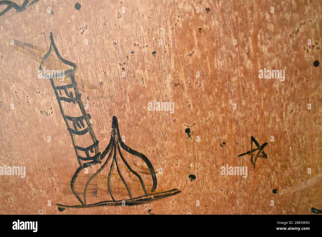 closeup view of mosque draw by one kid with black paint in brown background door.Day time photography with Nikon camera on april 2020. Stock Photo