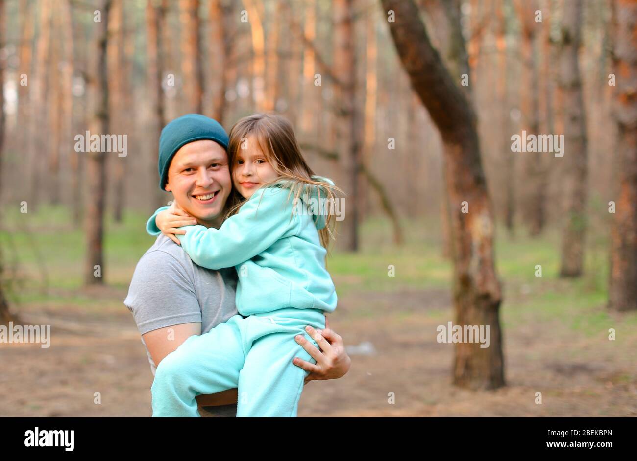 Young happy father holding daughter in park Stock Photo - Alamy