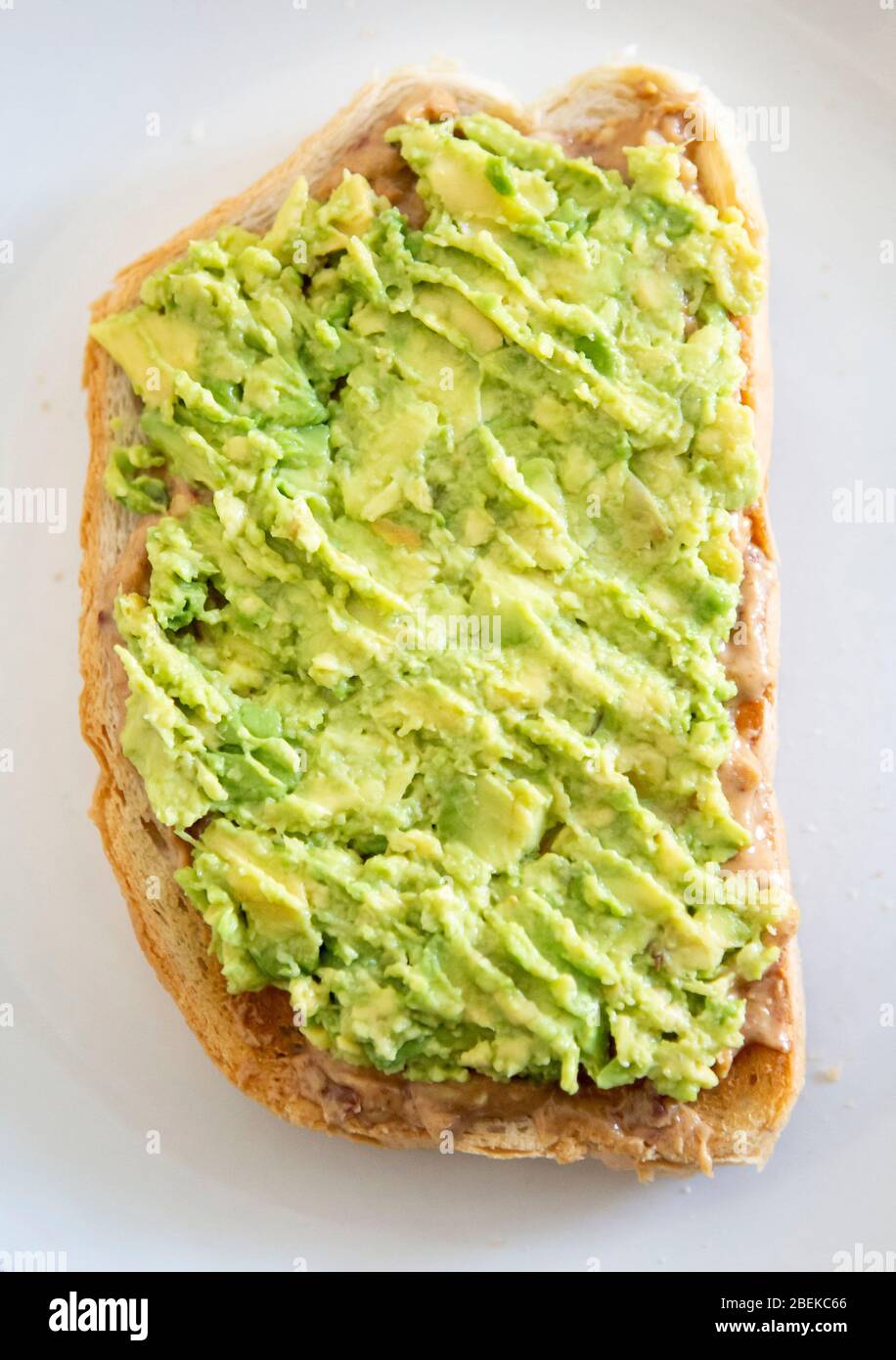 Avocado and peanut butter on toast Stock Photo Alamy
