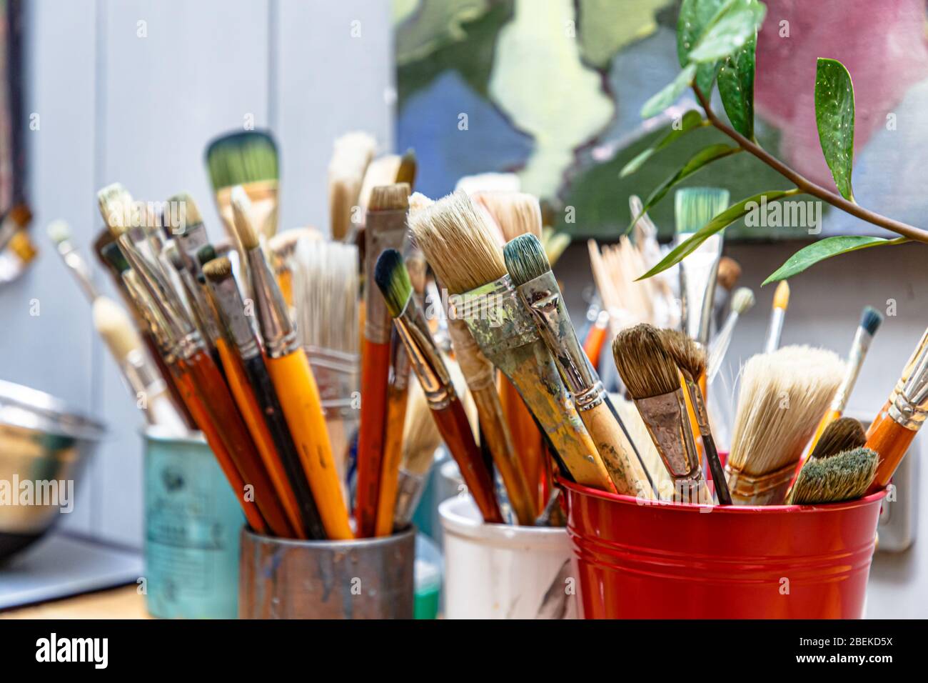 Brushes are in a glass in the artist's Studio Stock Photo Alamy
