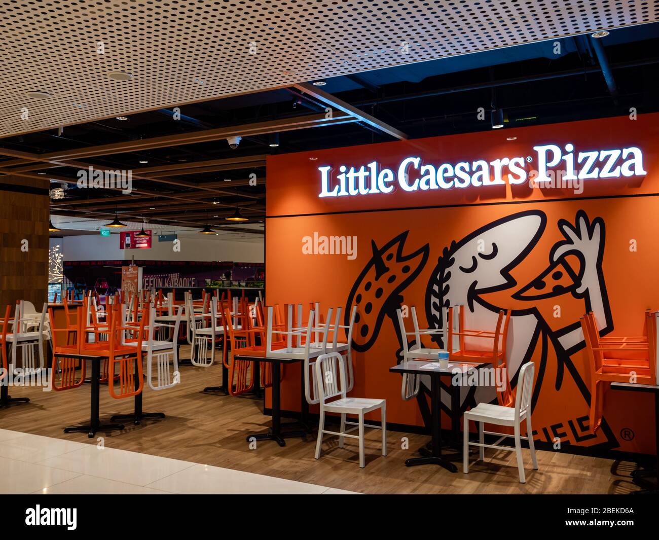 SINGAPORE – 9 APR 2020 – Stacked chairs at the closed dine-in section of Little Caesar’s Pizza restaurant in Thompson plaza. Only takeaway is allowed Stock Photo