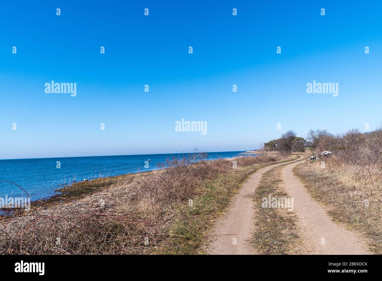 Gravel road along the coast on the island Oland in Sweden Stock Photo