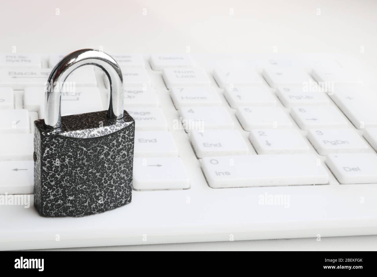 Selective focus Closed padlock on a white keyboard. Cybersecurity concept. Security Lock Stock Photo