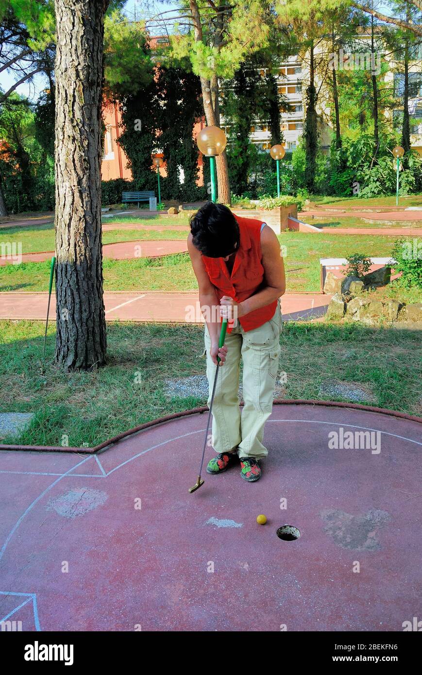 A woman is playing at miniature golf Stock Photo