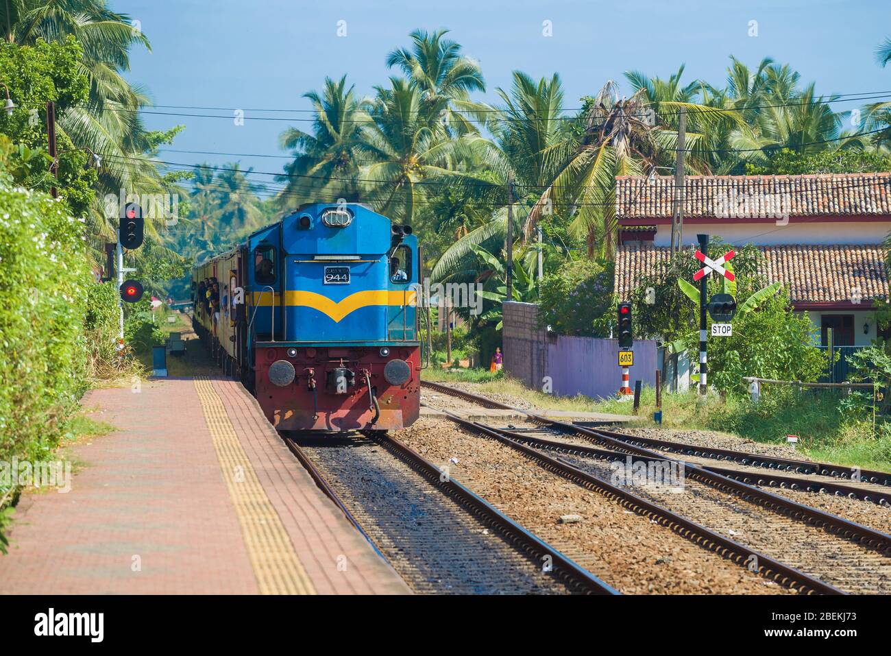 HIKKADUWA, SRI LANKA - FEBRUARY 21, 2020: Passenger train arrives on Hikkaduwa station Stock Photo