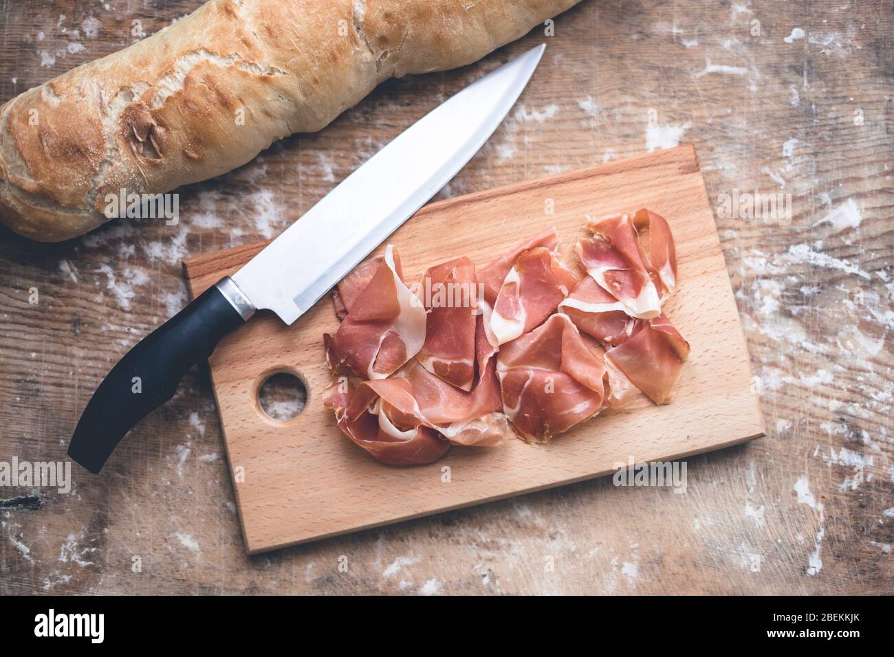 Spanish prosciutto, baguette and knife Stock Photo Alamy