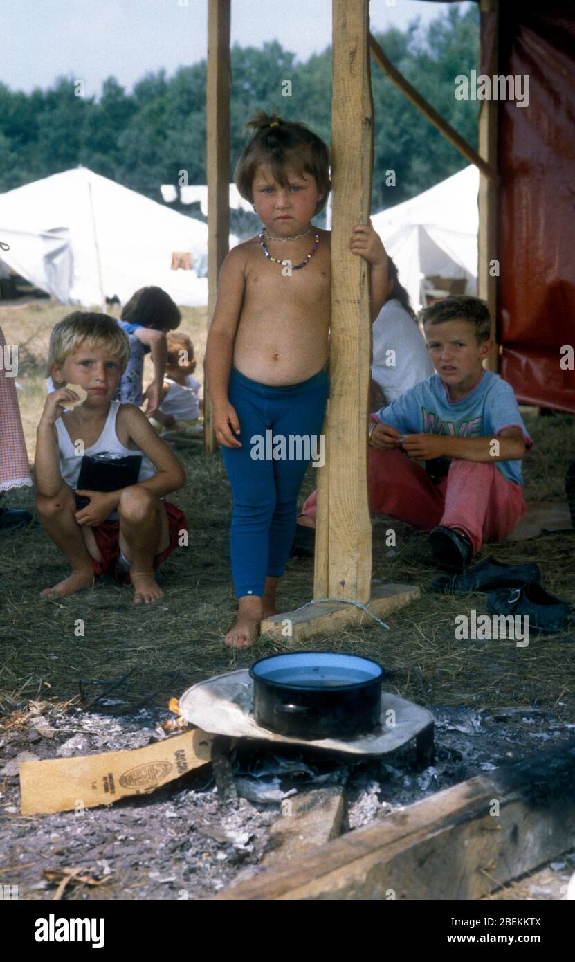 1995 Tuzla, Bosnia -  homeless child refugees at Tuzla airfield temporary refugee camp for Bosnian Muslims fleeing the Srebrenica Massacre during the Bosnian war Stock Photo