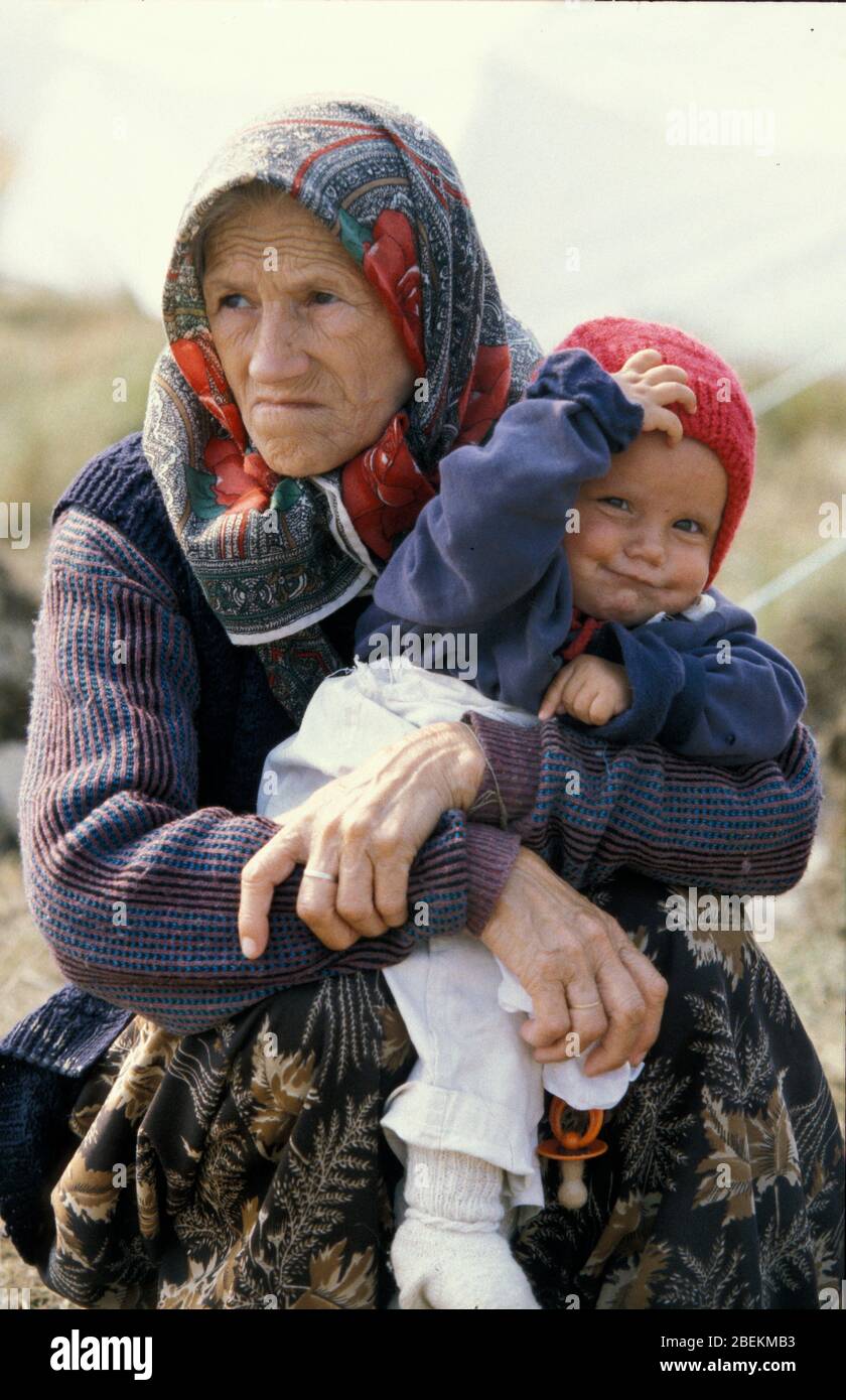 1995 Tuzla - elderly female refugee and grandchild who fled the Srebrenica Massacre pictured at the UN Tuzla airfield temporary refugee camp for Bosnian Muslims during the Bosnian war Stock Photo