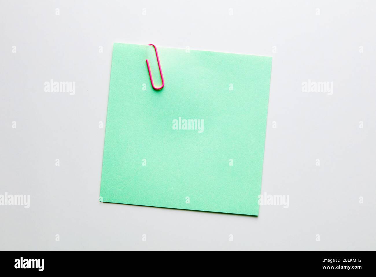 Green Paper Notepad Blank green note paper or notepad with a red paper clip on white ...