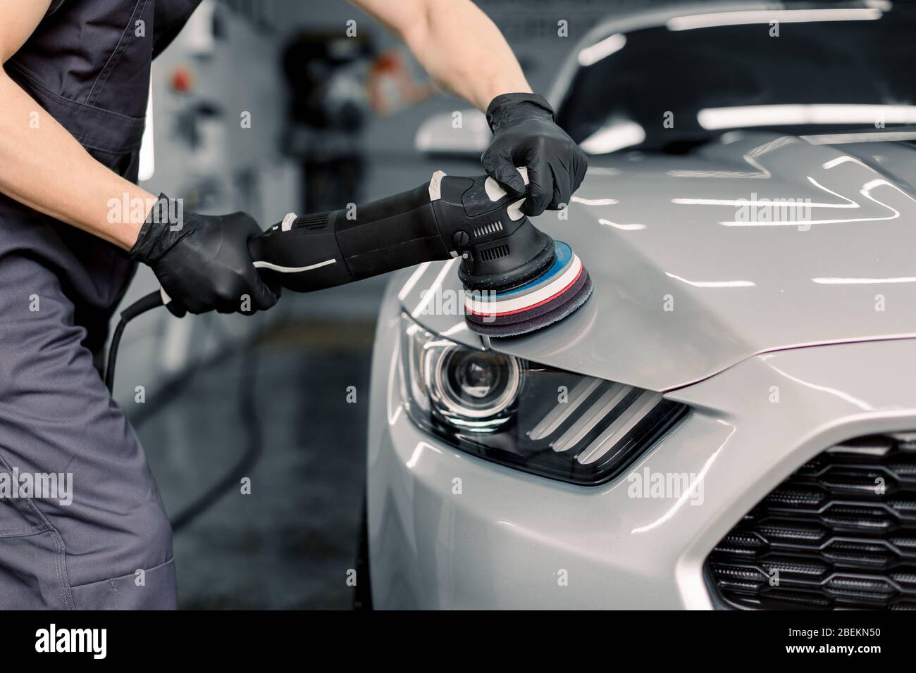 Car detailing and polishing concept. Hands of professional car service