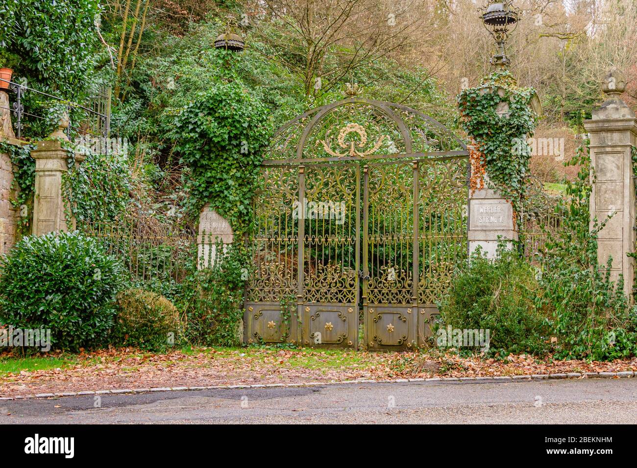 An overgrown formerly very grand gateway in the German spa town of Baden-Baden, Germany. January 2020. Stock Photo