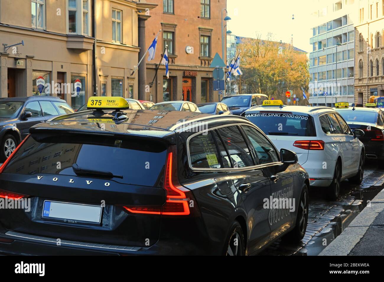Taxi cab line up or taxi queue by narrow street on a day of spring. Helsinki, Finland. March 19, 2020. Stock Photo