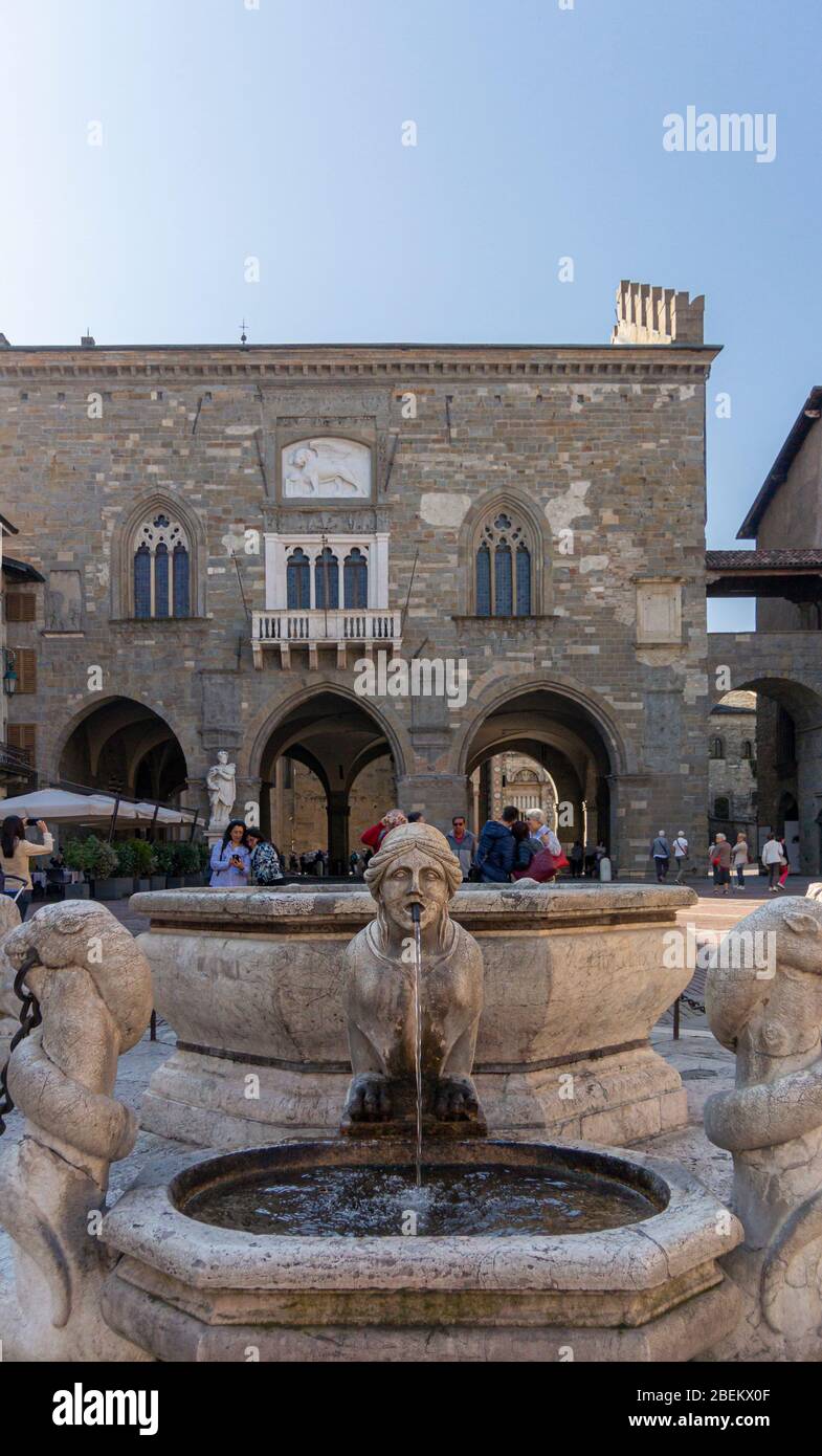 View of an ornate fountain Palace and Town Hall in the ancient city of Bergamo, Italy Stock Photo