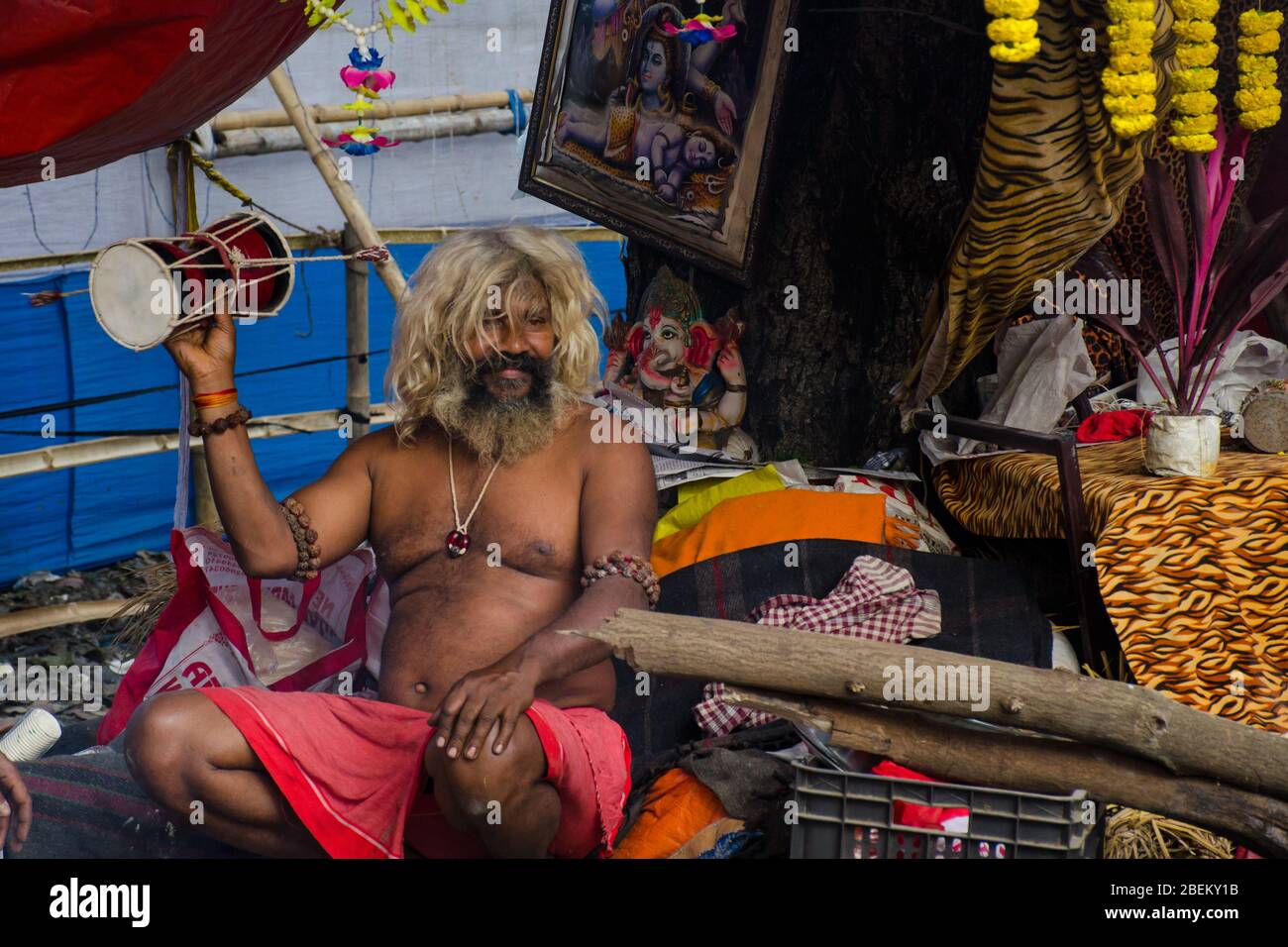 naga sadhu playing daaru a musical instrument of shiva at transit camp kolkata west bengal india Stock Photo
