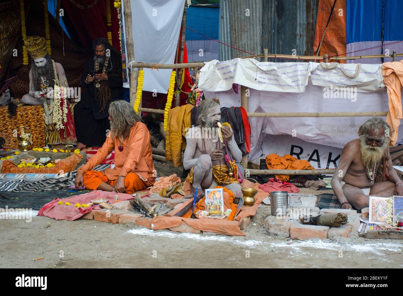 sadhu and naga sadhu sitting on footpath at ganga sagar transit camp kolkata west bengal india Stock Photo
