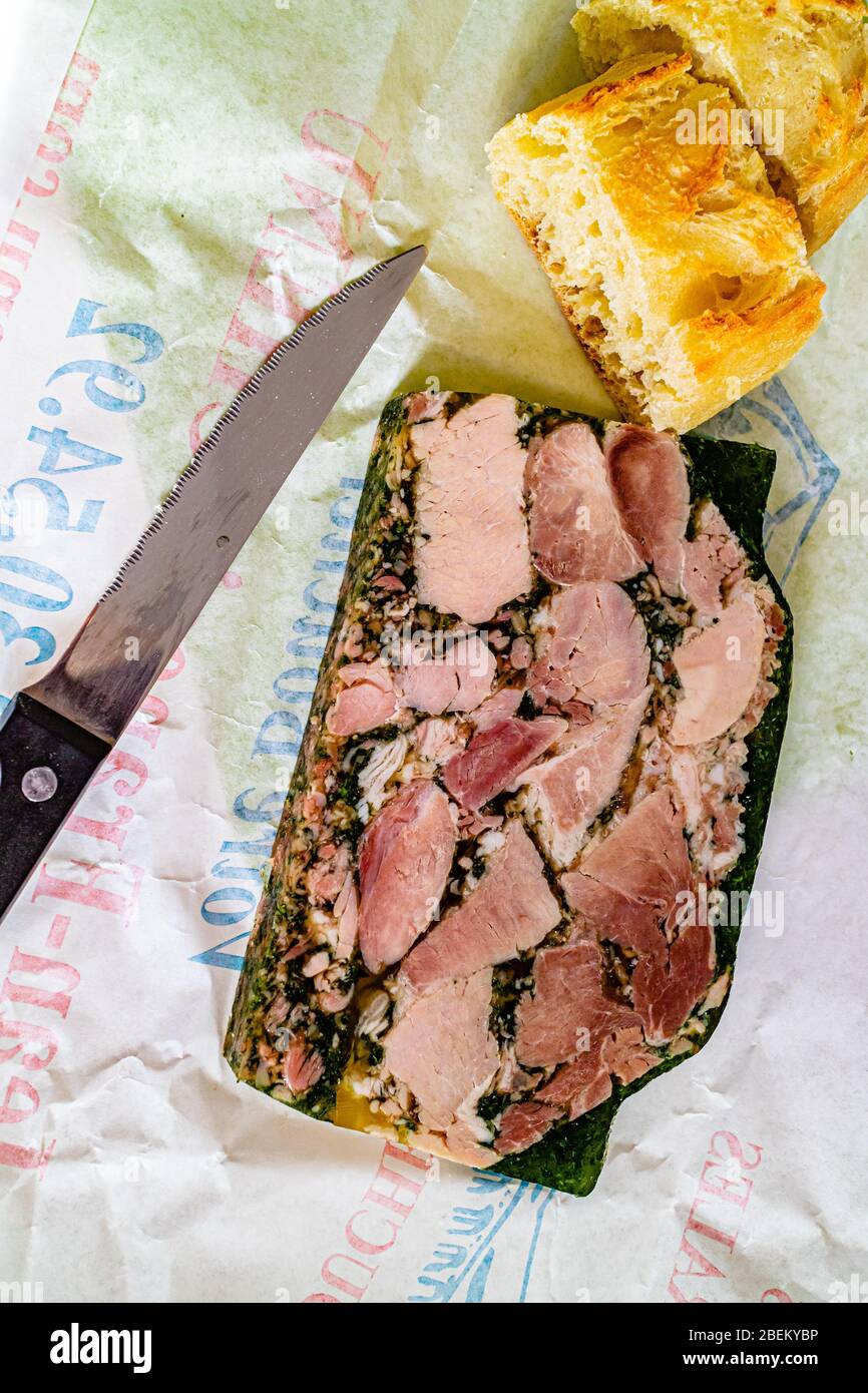 Jambon Persillé, or Parsley Ham - ham hock made into a terrine with parsley in aspic. A local food from the region of Burgundy. Dijon, France. 2020. Stock Photo