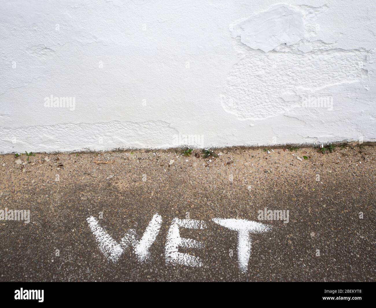 White wet paint sign on pavement Stock Photo Alamy