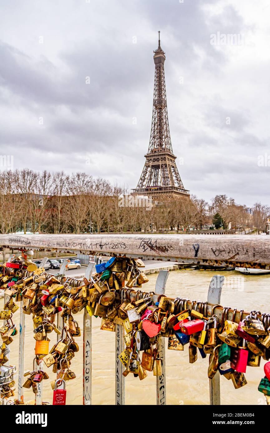 Love padlocks on the Debilly footbridge over the River Seine, with the Eiffel Tower behind. Paris, France. February 2020. Stock Photo